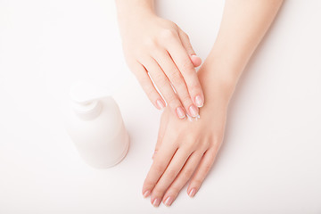 Image showing Beautiful female hand applying cream
