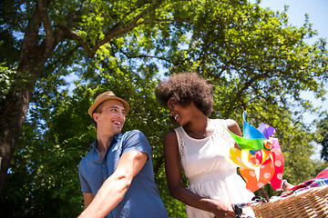 Image showing Young multiethnic couple having a bike ride in nature