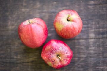 Image showing Three red apples on wooden table