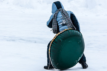 Image showing Baby winter sledding on the Ural River,