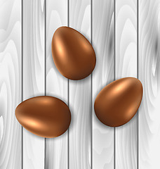 Image showing Easter chocolate three eggs on grey wooden background