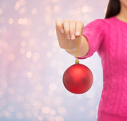 Image showing close up of woman in sweater with christmas ball