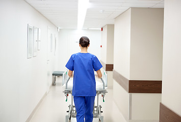 Image showing nurse carrying hospital gurney to emergency room