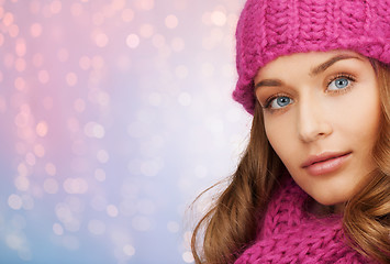 Image showing close up of woman in hat and scarf over lights