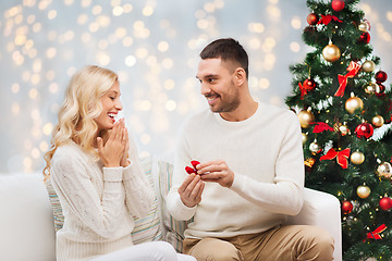 Image showing man giving woman engagement ring for christmas