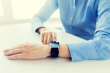 Image showing close up of hands setting smart watch