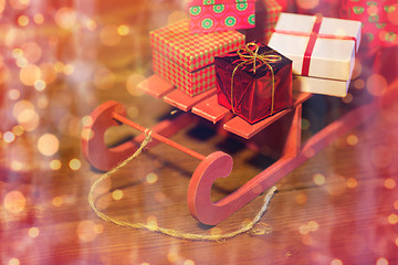 Image showing close up of christmas gift boxes on wooden sleigh