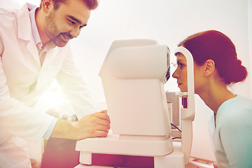 Image showing optician with tonometer and patient at eye clinic