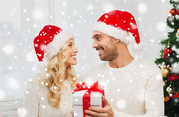 Image showing happy couple at home with christmas gift box