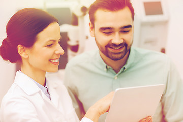 Image showing optician with tablet pc and patient at eye clinic