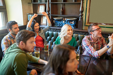 Image showing friends with beer watching football at bar or pub