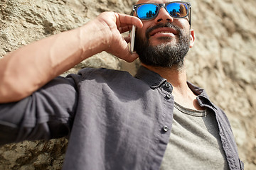 Image showing close up of man calling on smartphone in city