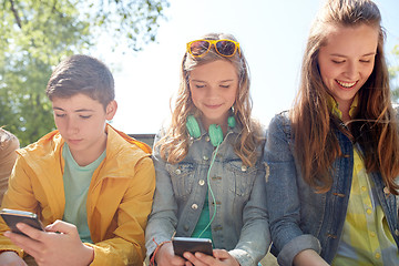 Image showing teenage friends with smartphone and headphones