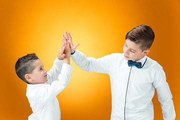 Image showing Happy children congratulating by palms with the victory