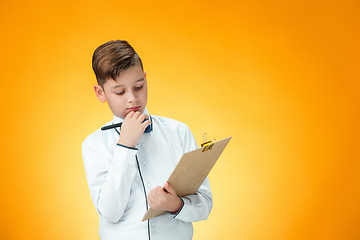 Image showing The boy with pen and tablet for notes