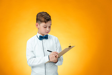 Image showing The boy with pen and tablet for notes