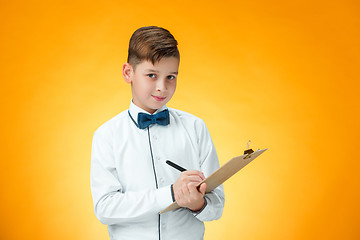 Image showing The boy with pen and tablet for notes