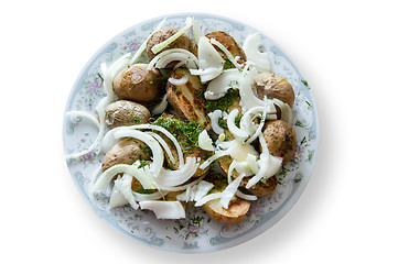 Image showing baked potatoes with the peel, onion and fennel, drizzled oil on a plate gray ornament. Isolation, cliping mask