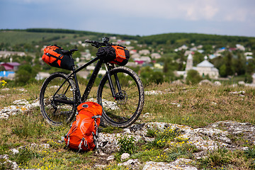 Image showing Bicycle with orange bags for travel