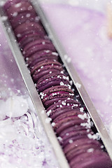 Image showing Purple macarons lying in silver box