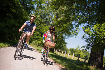 Image showing Young multiethnic couple having a bike ride in nature