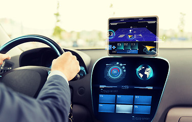 Image showing close up of man driving car with navigation system