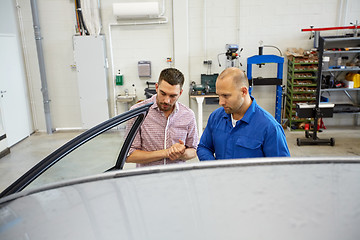 Image showing auto mechanic and man at car shop