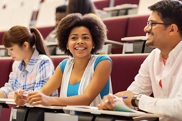 Image showing group of students with notebooks in lecture hall