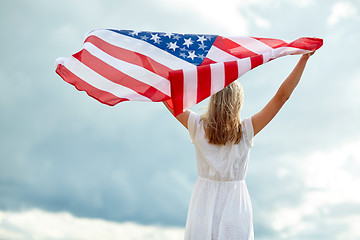 Image showing happy young woman with american flag outdoors