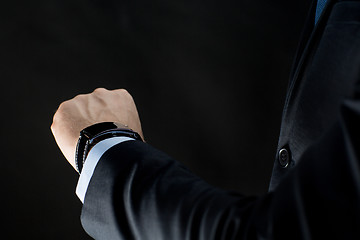 Image showing close up of businessman hand with smart watch