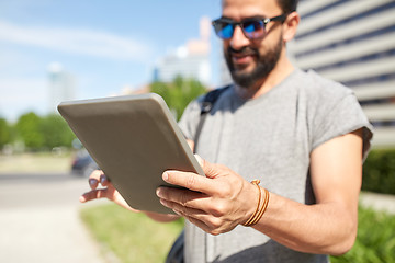 Image showing close up of man with tablet pc in city