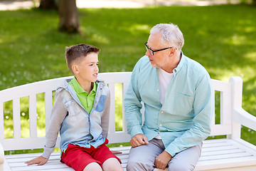 Image showing grandfather and grandson talking at summer park