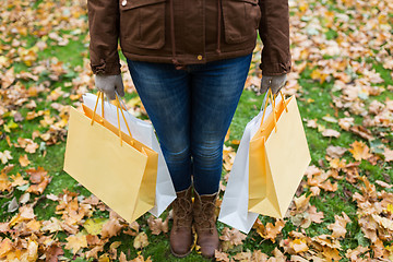 Image showing woman with shopping bags in autumn park