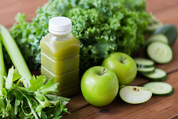 Image showing close up of bottle with green juice and vegetables