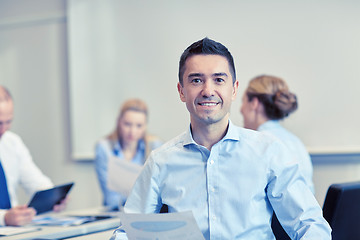 Image showing smiling group of businesspeople meeting in office