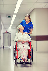 Image showing nurse with senior woman in wheelchair at hospital