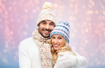 Image showing smiling couple in winter clothes hugging