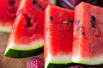 Image showing close up of watermelon slices on wooden table