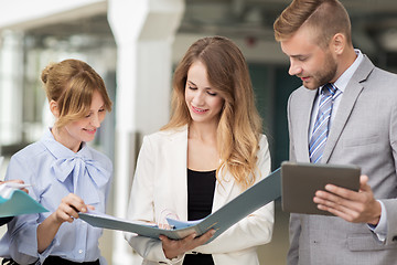 Image showing business team with tablet pc and folders at office