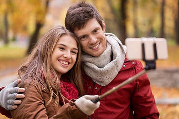 Image showing couple taking selfie by smartphone in autumn park