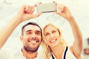 Image showing happy couple taking selfie with smartphone 