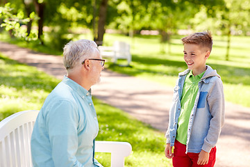 Image showing grandfather and grandson talking at summer park