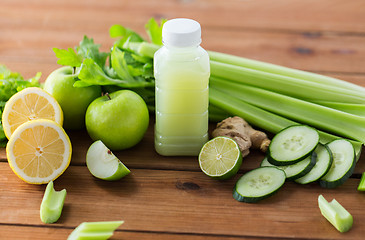 Image showing close up of bottle with green juice and vegetables