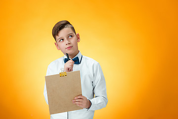 Image showing The boy with pen and tablet for notes