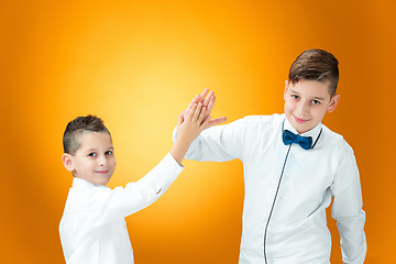 Image showing Happy children congratulating by palms with the victory