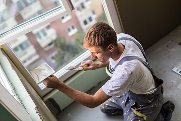 Image showing Plasterer renovating indoor walls and ceilings.