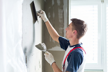 Image showing Plasterer renovating indoor walls and ceilings.