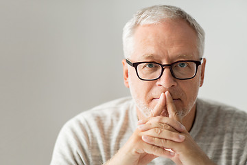 Image showing close up of senior man in glasses thinking