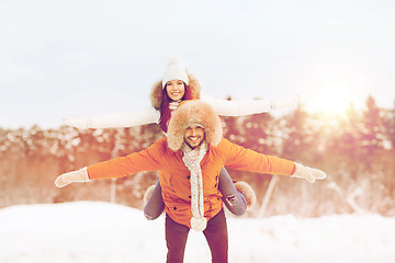 Image showing happy couple having fun over winter background