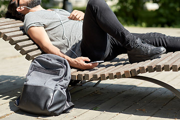 Image showing man with smartphone and earphones listening music